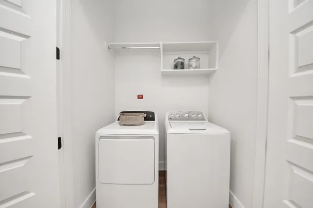 a living room with furniture fireplace and large windows