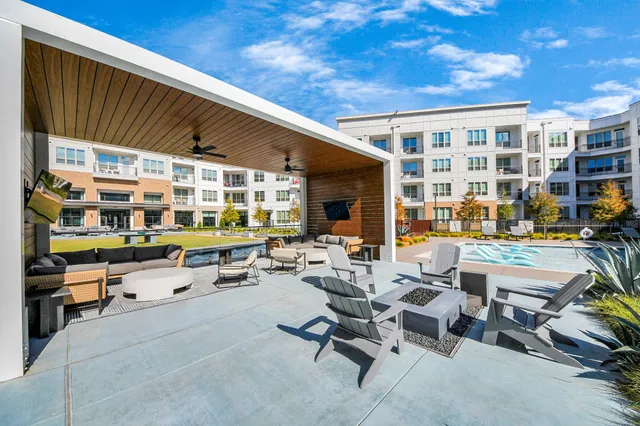 a building outdoor space with patio furniture and potted plants