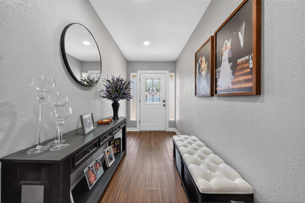 614 Colonial Drive Athens, TX 75751 - Photo 4 of 26 a hallway with a large mirror and a plant