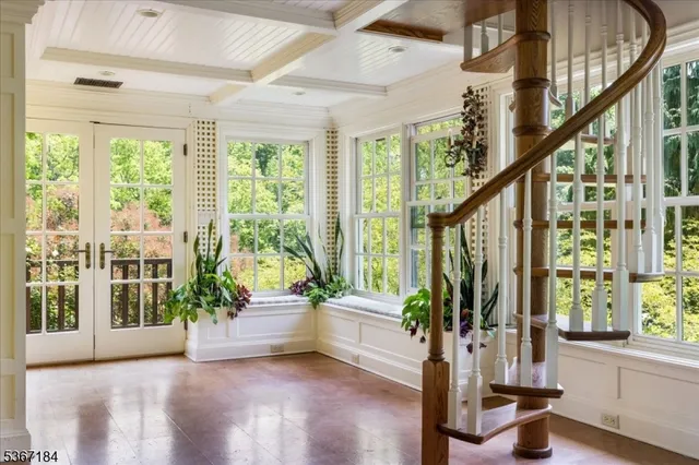 a view of an entryway with wooden floor and windows