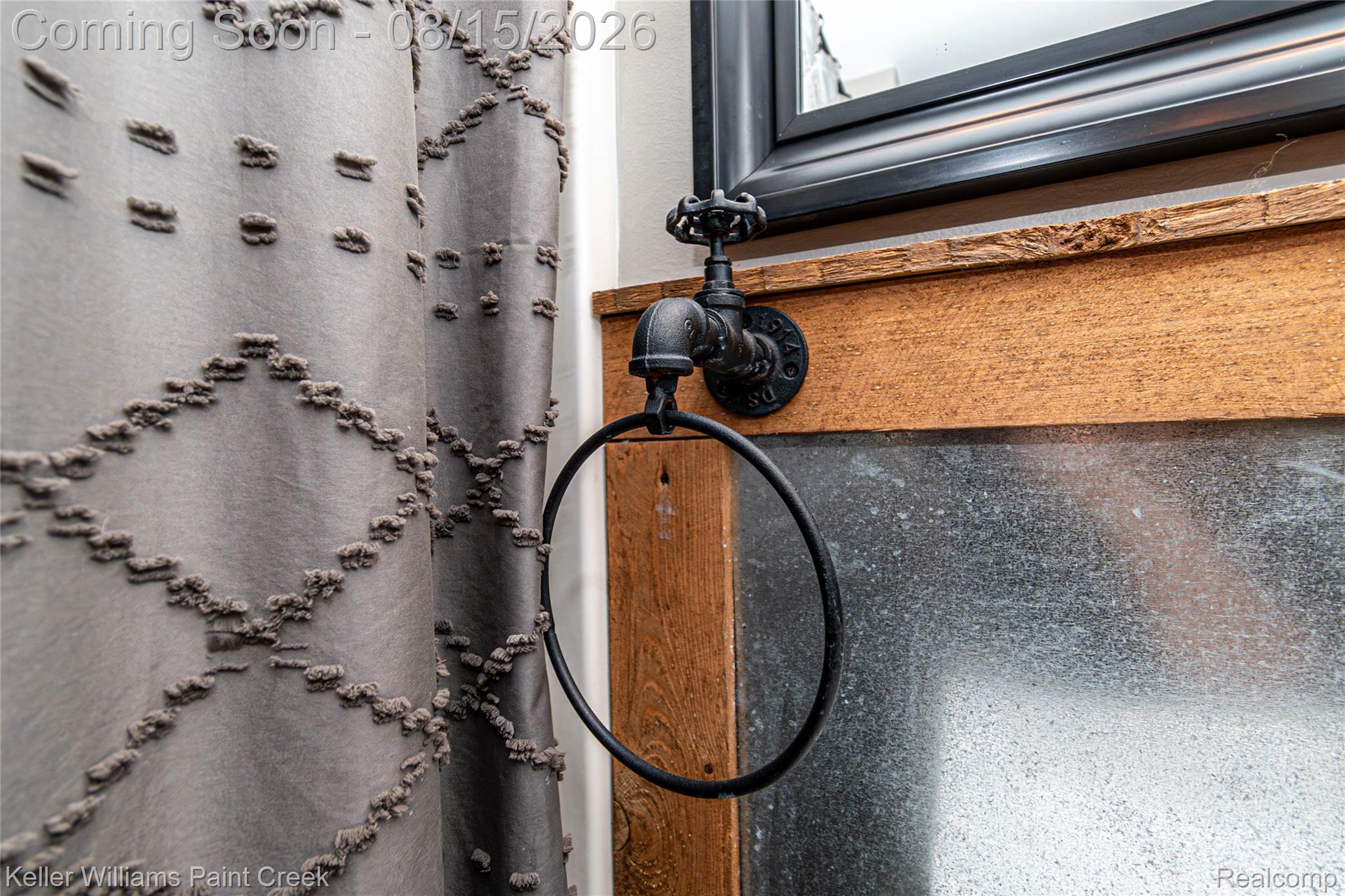 330 East Washington Street Romeo, MI 48065 - Photo 50 of 68 Industrial-style towel ring, decorative mirror, and wood-finish trim