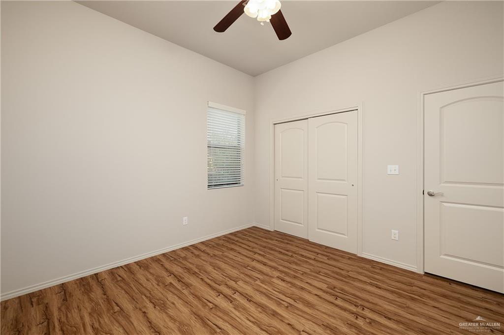 810 South Taylor Road Mission, TX 78572 - Photo 15 of 17 Unfurnished bedroom featuring light wood-style floors, a closet, and a ceiling fan