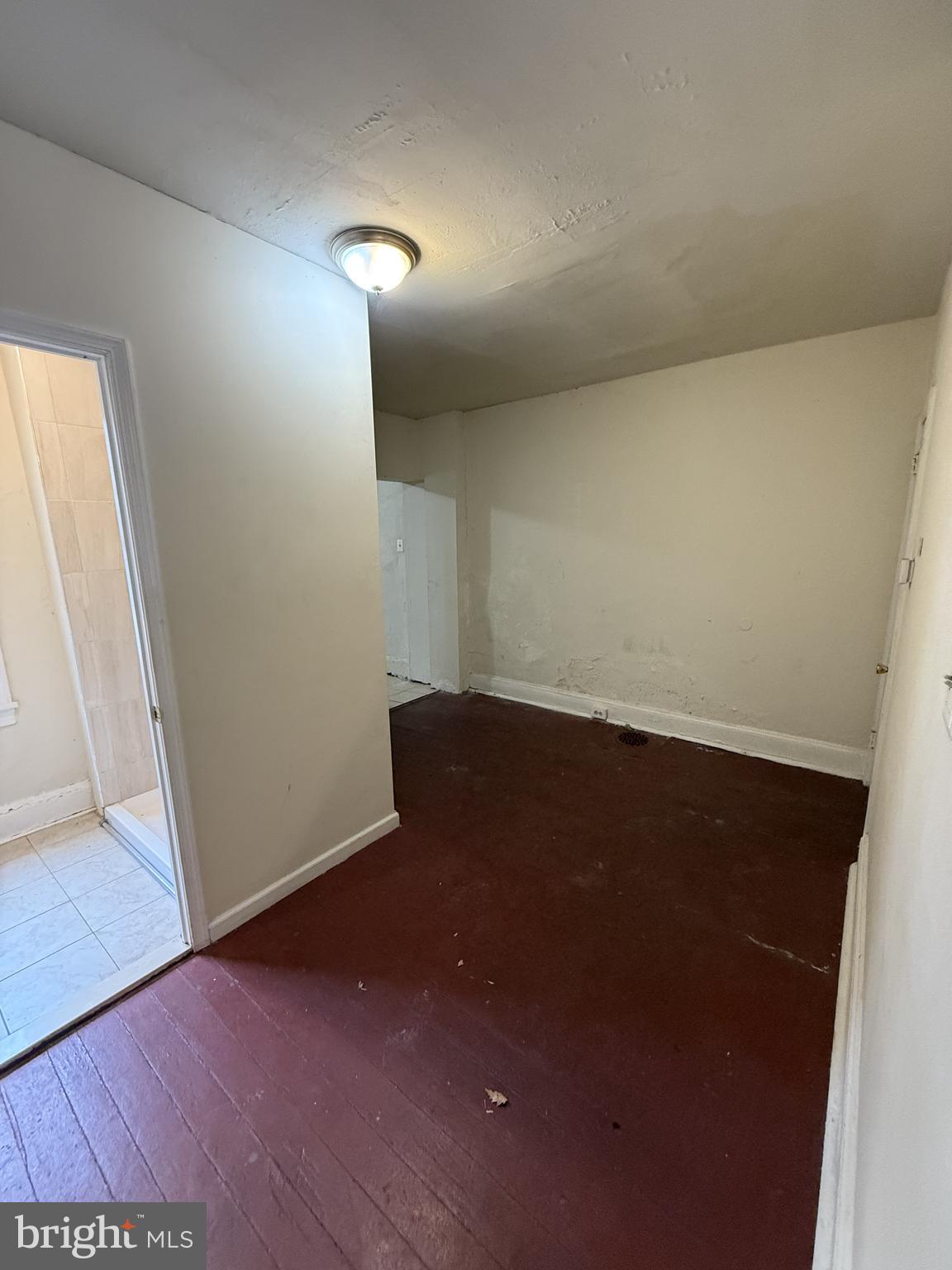 3203 Pearl Street Philadelphia, PA 19104 - Photo 3 of 12 an empty room with wooden floor and windows