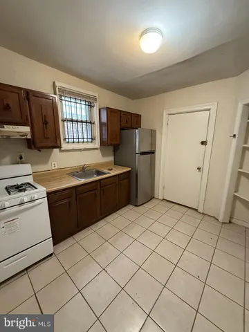 a kitchen with stainless steel appliances granite countertop a refrigerator sink and stove
