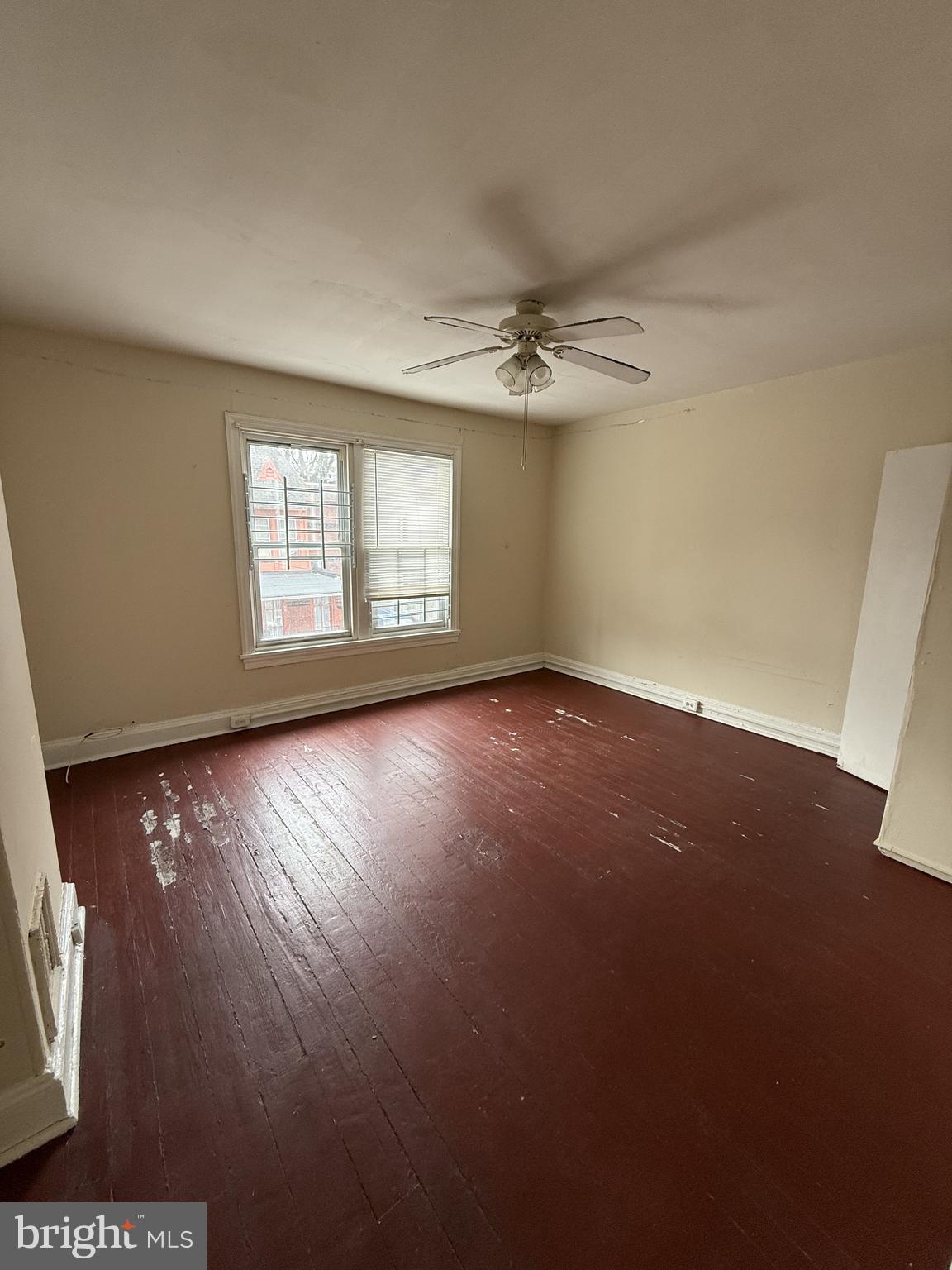3203 Pearl Street Philadelphia, PA 19104 - Photo 9 of 12 an empty room with wooden floor and windows
