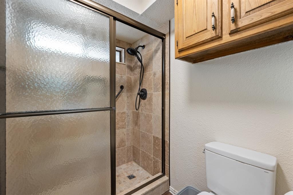 403 Riva Ridge Wylie, TX 75098 - Photo 19 of 32 Tiled shower enclosure with a bronze-finish frame and fixtures