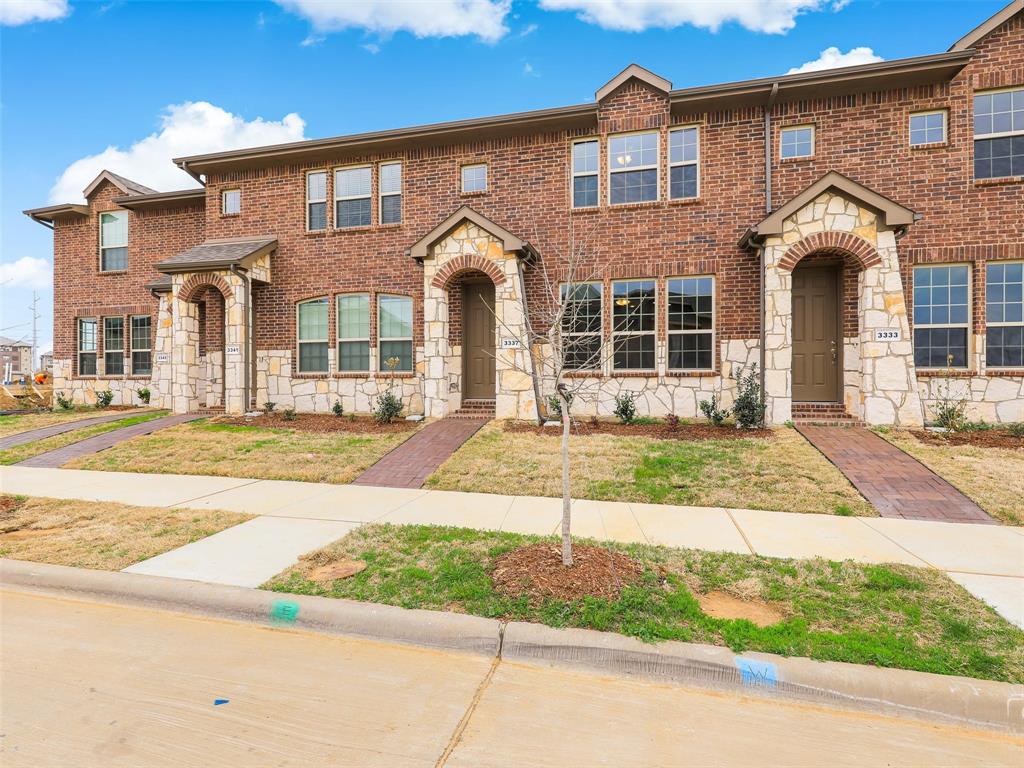 View of front of home featuring stone siding and brick siding
