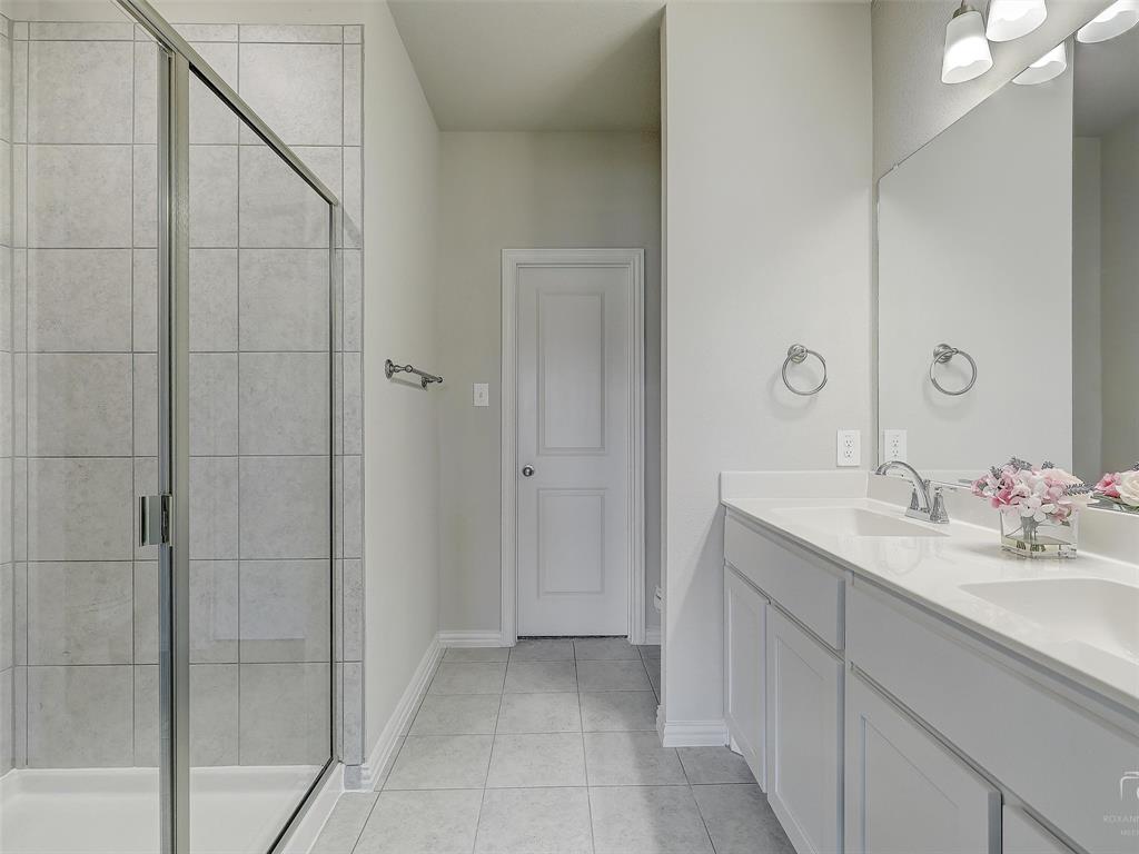 3337 Solana Circle Denton, TX 76207 - Photo 17 of 22 Full bathroom featuring tile patterned floors, double vanity, and a shower stall