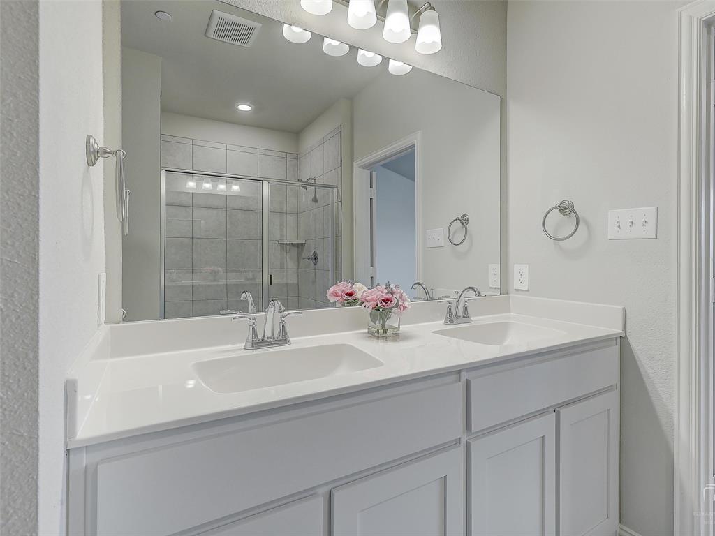 3337 Solana Circle Denton, TX 76207 - Photo 18 of 22 Full bath with double vanity and a tile shower