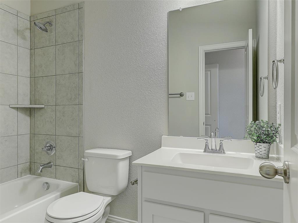 3337 Solana Circle Denton, TX 76207 - Photo 21 of 22 Full bathroom with vanity, a textured wall, and shower / bathtub combination