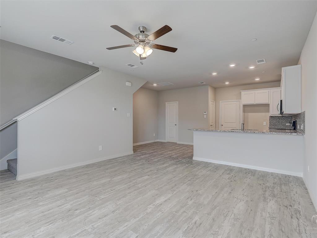 3337 Solana Circle Denton, TX 76207 - Photo 5 of 22 Unfurnished living room featuring recessed lighting, ceiling fan, light wood-style floors, and stairway