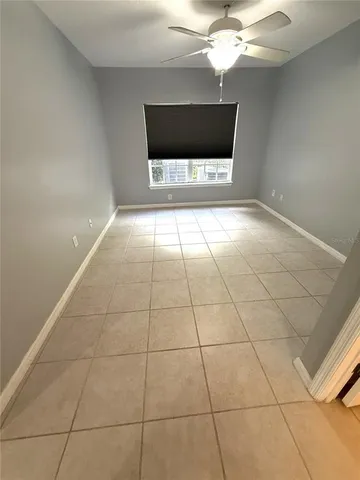 a living room with a baby crib furniture a chandelier and a window