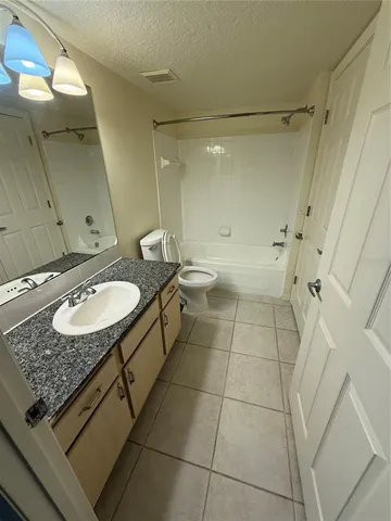a view of a livingroom with white tiles
