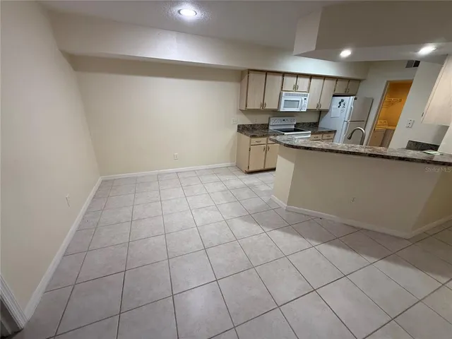 a view of a kitchen with a sink and chandelier fan
