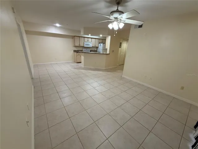 a view of a kitchen with kitchen appliances and a floor to ceiling window