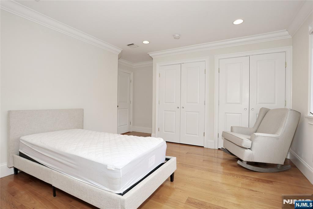 65 Ross Avenue Demarest, NJ 07627 - Photo 32 of 48 a spacious bedroom with a bed and a couch