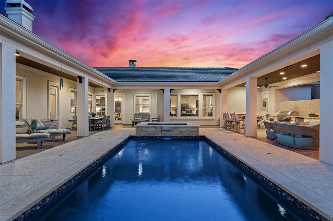 a large open kitchen with granite countertop a lot of counter space and a wooden floor
