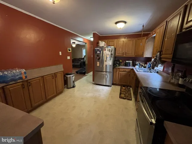 a kitchen with sink refrigerator and microwave