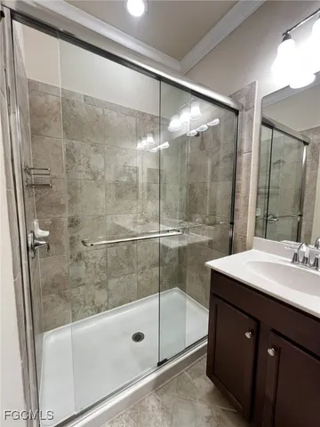 a bathroom with a shower sink and mirror