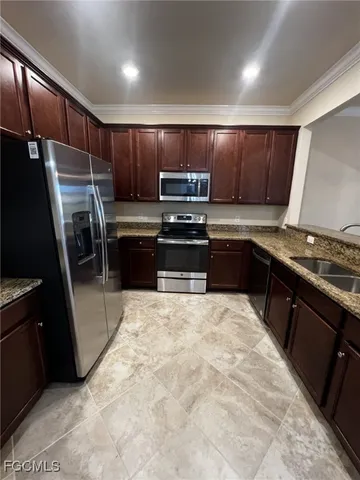 a kitchen with wooden cabinets and a stove top oven