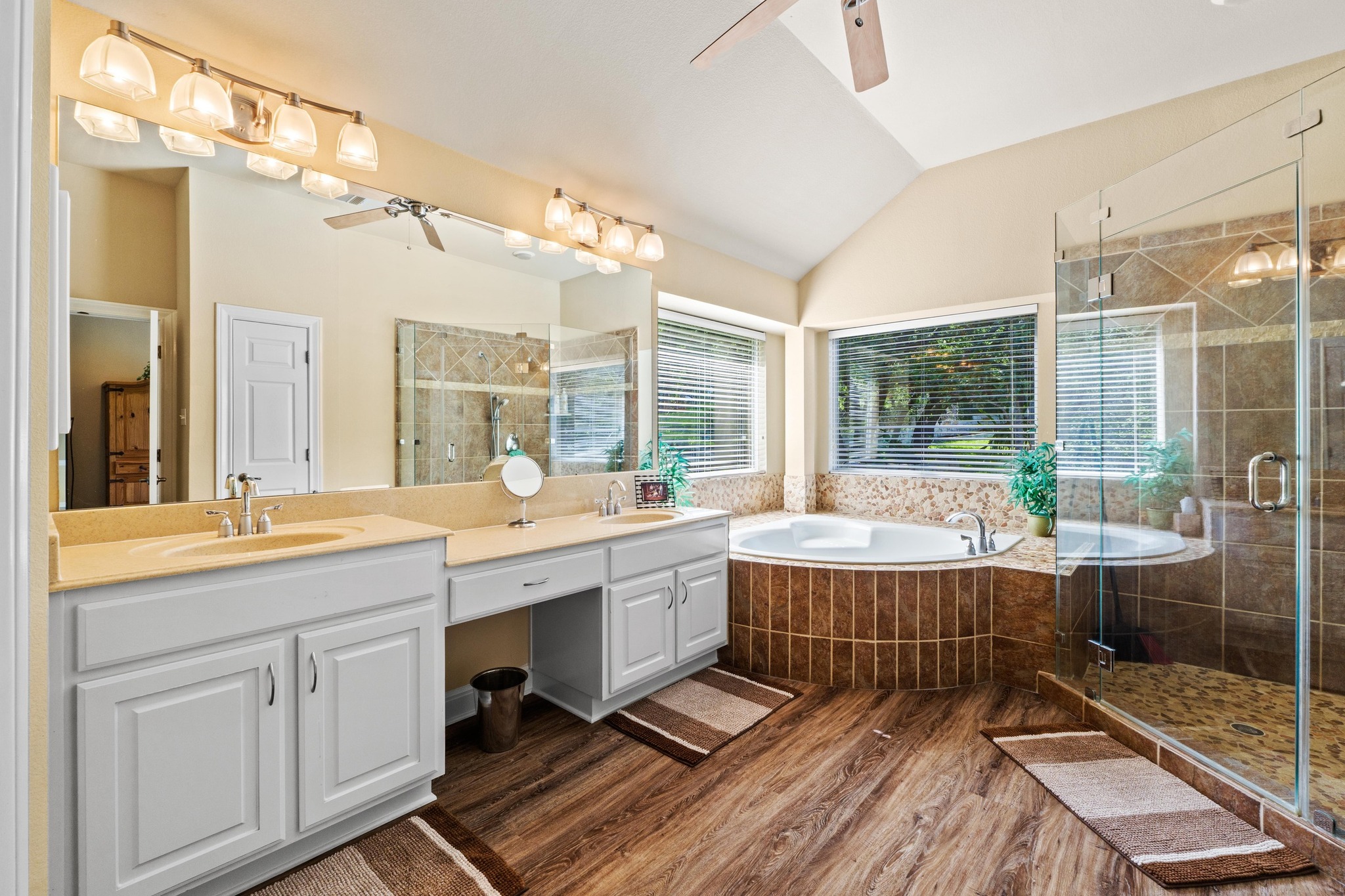 135 Tumbleweed Trail North Austin, TX 78733 - Photo 13 of 39 The primary bathroom has a his & hers double vanity, a large soaking tub, and an extra large walk-in shower.