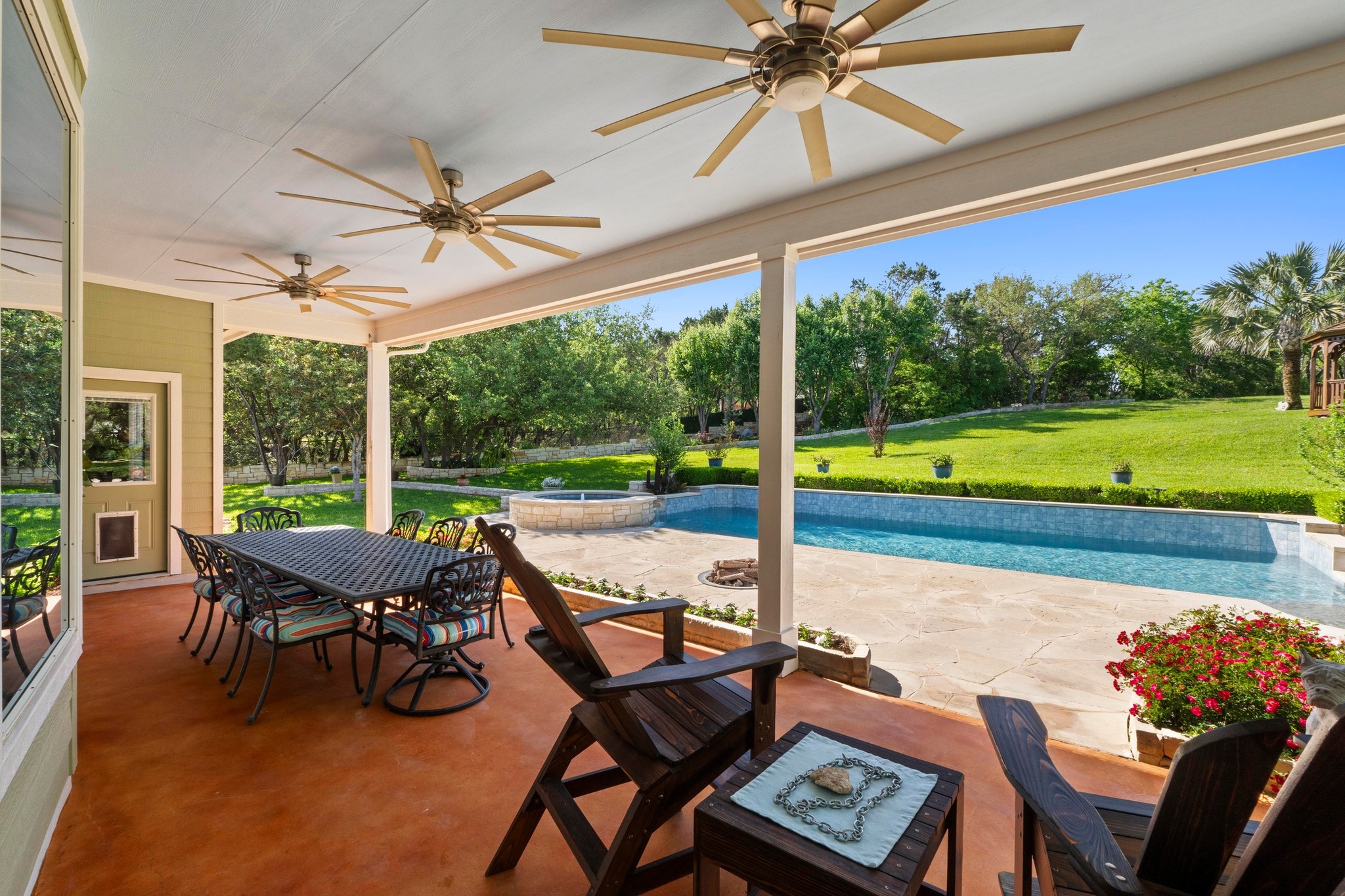 135 Tumbleweed Trail North Austin, TX 78733 - Photo 20 of 39 The extra-large covered patio has three Big Ass ceiling fans and great views.