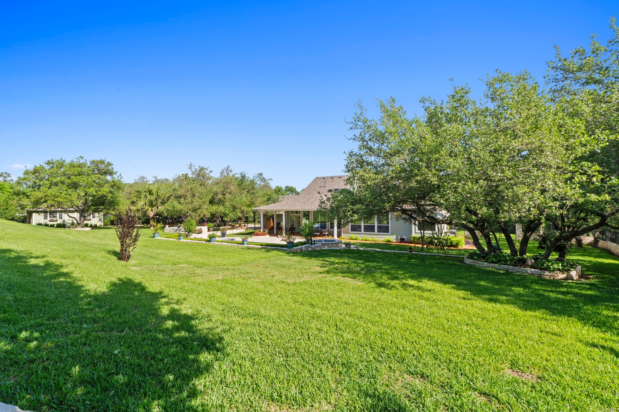 135 Tumbleweed Trail North Austin, TX 78733 - Photo 25 of 39 View of the back of the house from the hill in the backyard.