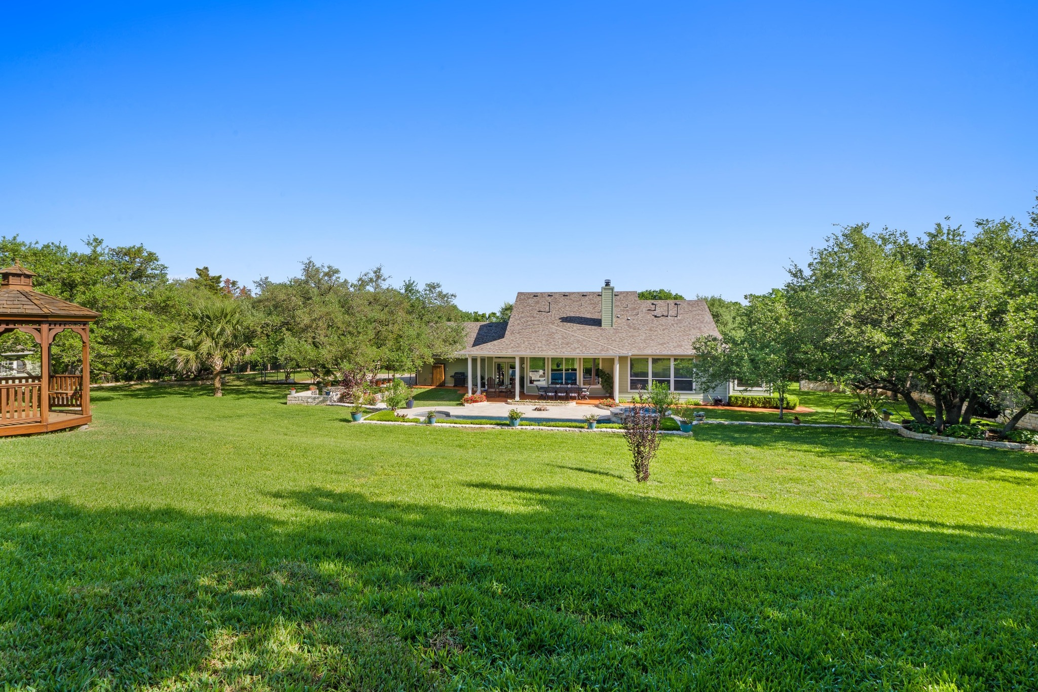 135 Tumbleweed Trail North Austin, TX 78733 - Photo 26 of 39 View of a grassy yard featuring the gazebo and a patio area