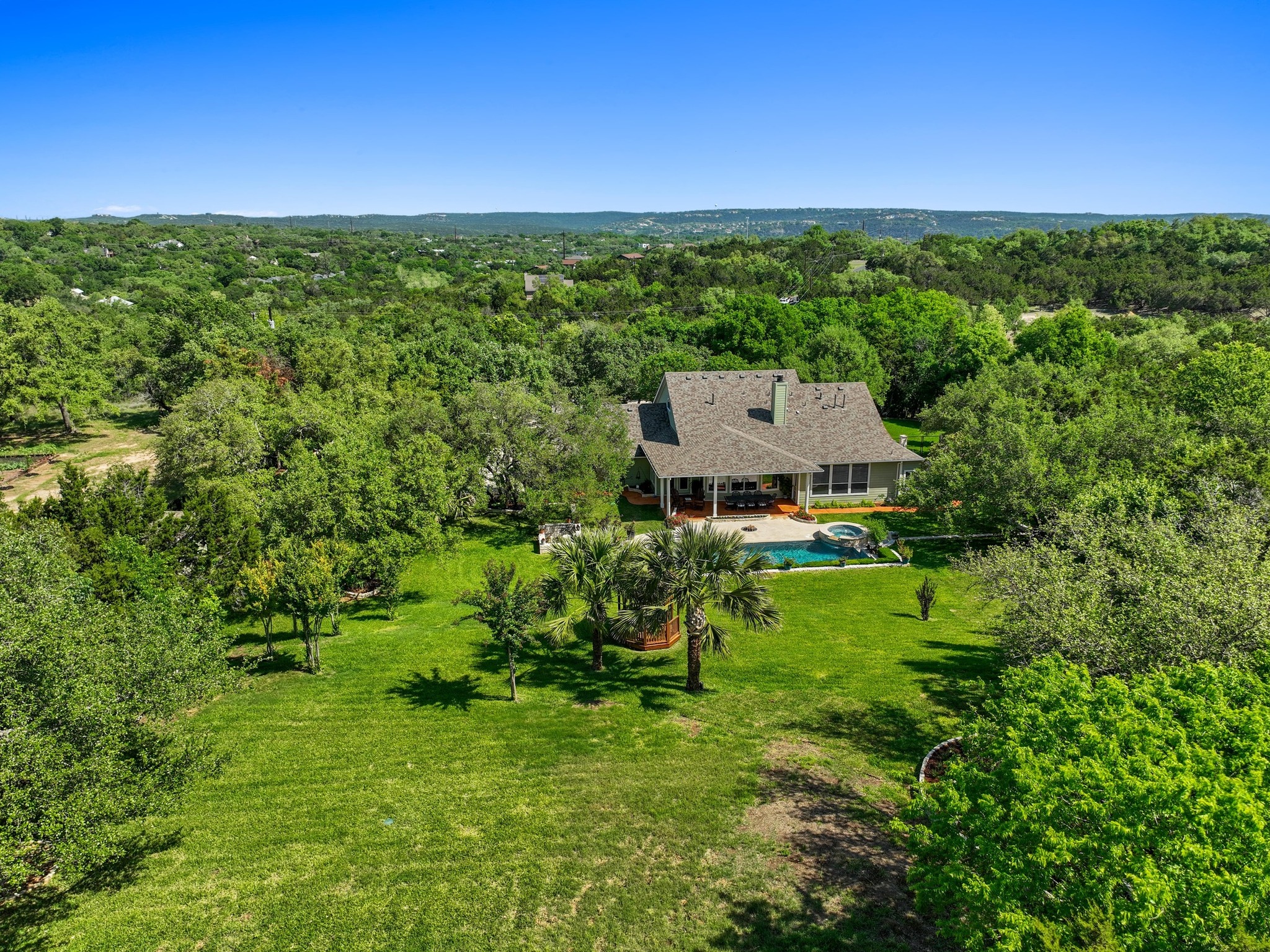 135 Tumbleweed Trail North Austin, TX 78733 - Photo 33 of 39 View from above of property with a forest and a pool