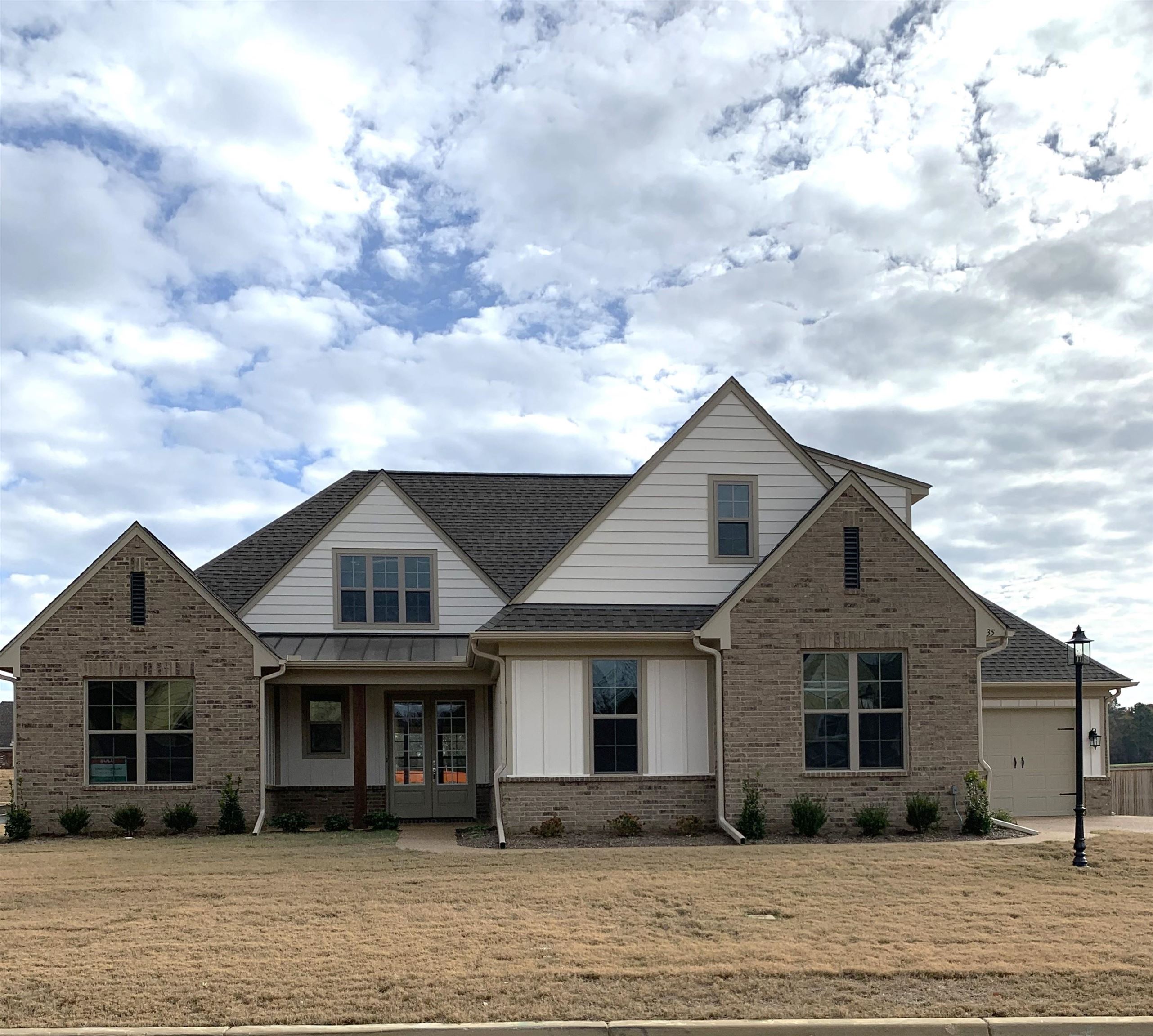 a front view of a house with a garden