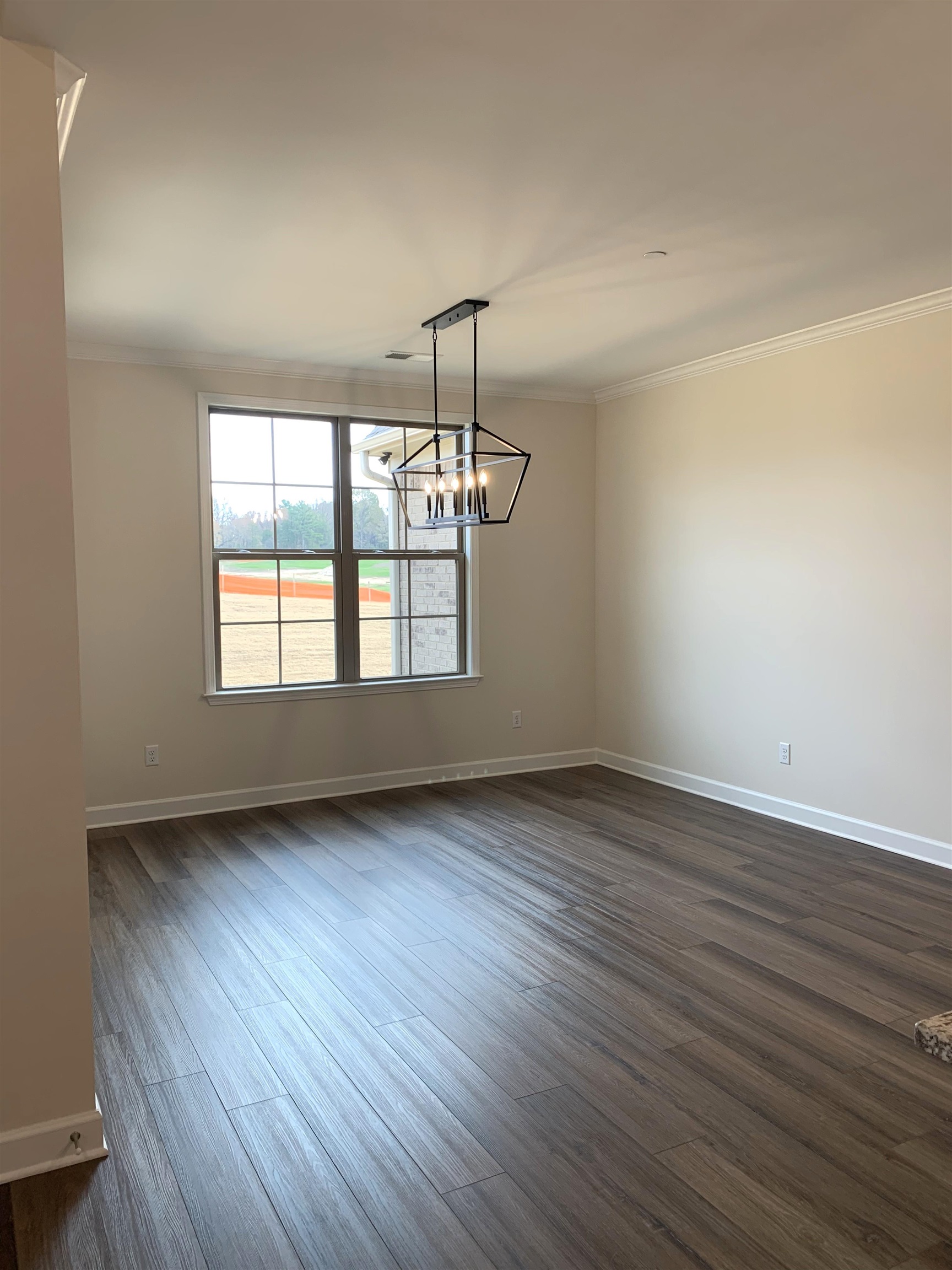 35 Grassy Hill Road Collierville, TN 38017 - Photo 11 of 33 an empty room with wooden floor and windows