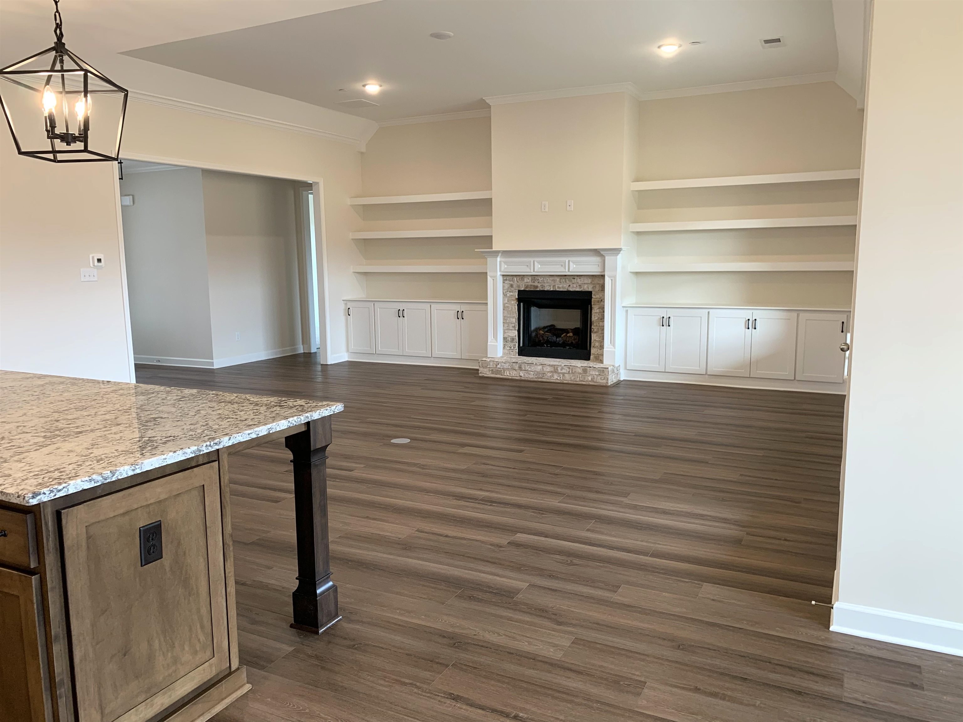 35 Grassy Hill Road Collierville, TN 38017 - Photo 12 of 33 a view of empty room with wooden floor and fireplace