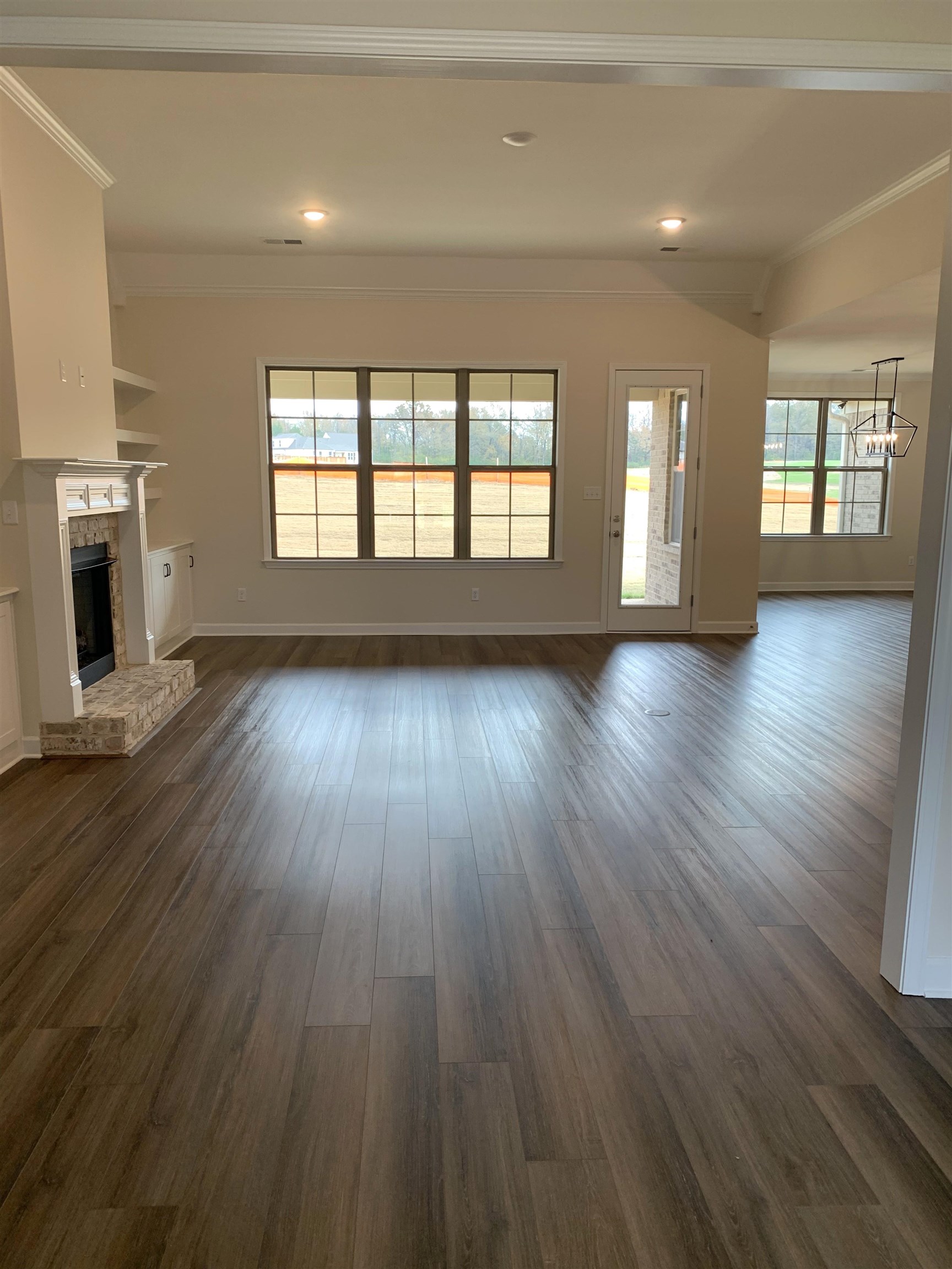 35 Grassy Hill Road Collierville, TN 38017 - Photo 13 of 33 an empty room with wooden floor and fireplace
