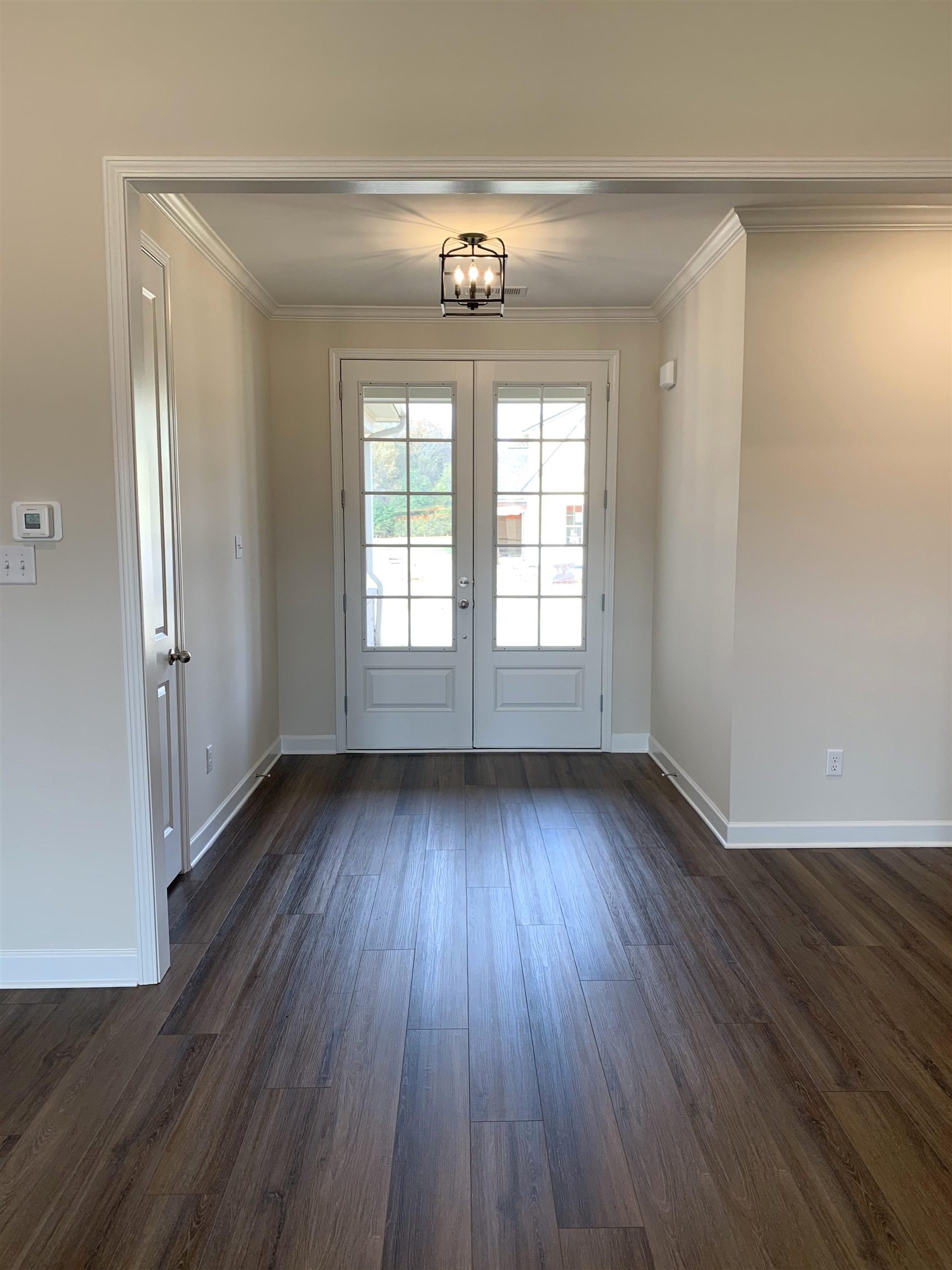 35 Grassy Hill Road Collierville, TN 38017 - Photo 3 of 33 an empty room with wooden floor and windows