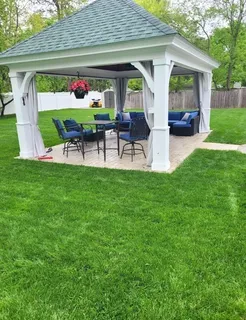 a view of a house with backyard sitting area and garden