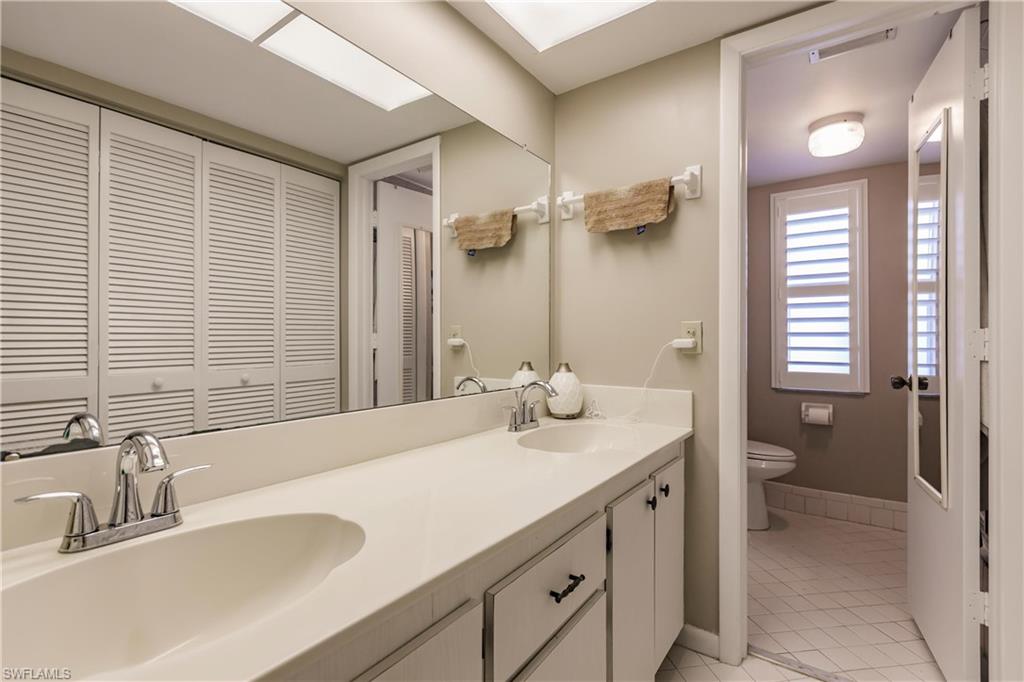 550 Teryl Road, Unit 2301 Naples, FL 34112 - Photo 15 of 31 a bathroom with a sink and a large mirror
