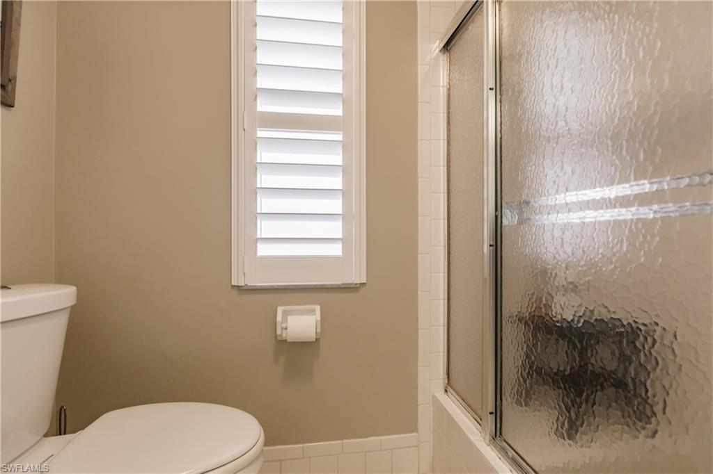 550 Teryl Road, Unit 2301 Naples, FL 34112 - Photo 16 of 31 a white toilet sitting next to a bathroom sink