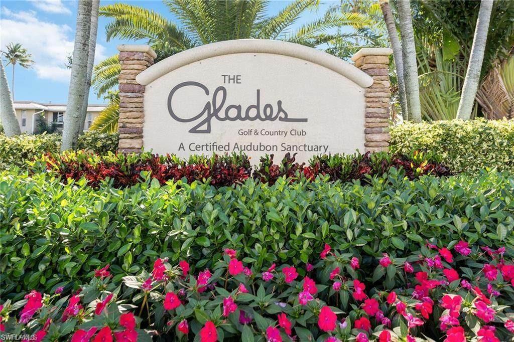 550 Teryl Road, Unit 2301 Naples, FL 34112 - Photo 27 of 31 a sign that is in front of flowers