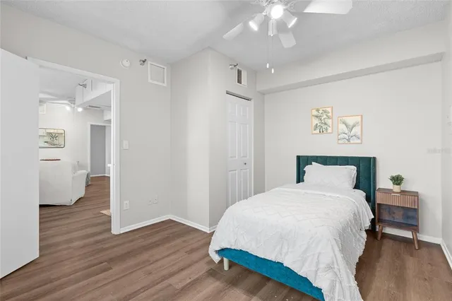 a bedroom with a bed and wooden floor