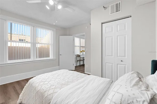 a bedroom with a bed and a window