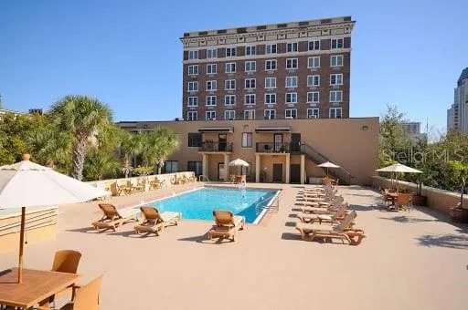 a view of a building with yard and sitting area