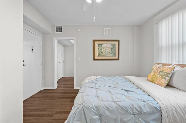 a bedroom with a bed and a painting