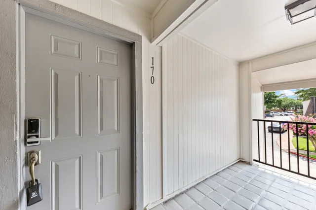 a view of a hallway with wooden floor and entryway