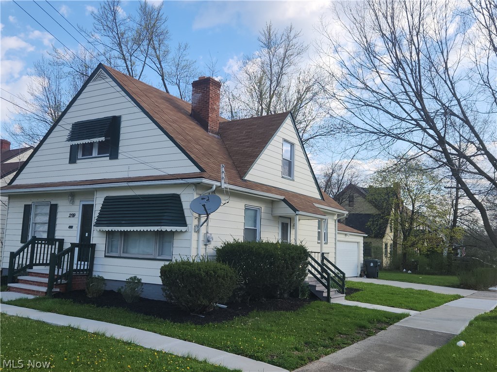 2199 North Taylor Road Cleveland Heights, OH 44112 - Photo 2 of 19 View of side of home with a yard and a garage