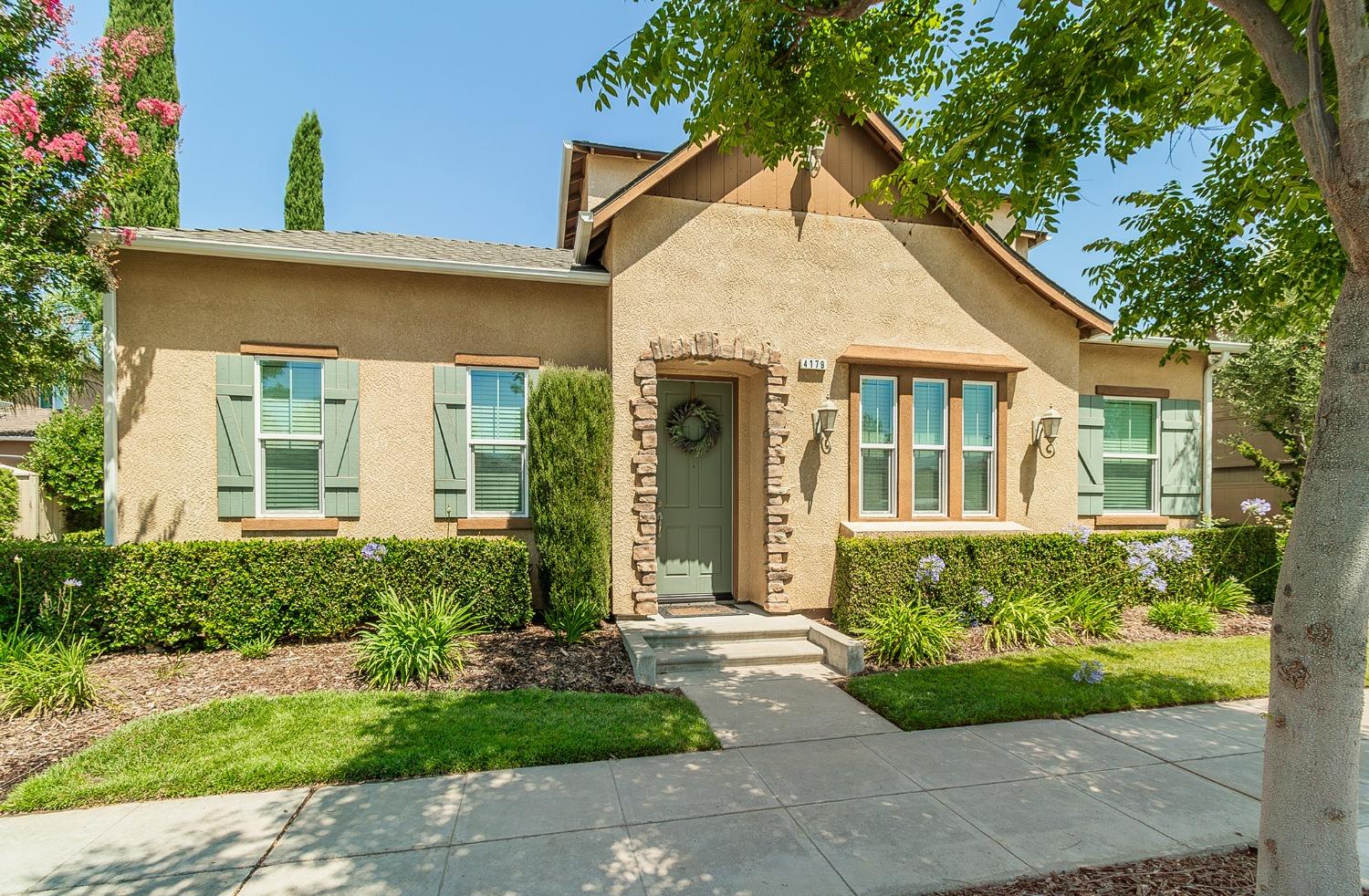 4179 Harlan Ranch Boulevard Clovis, CA 93619 - Photo 1 of 47 front view of a house with a yard