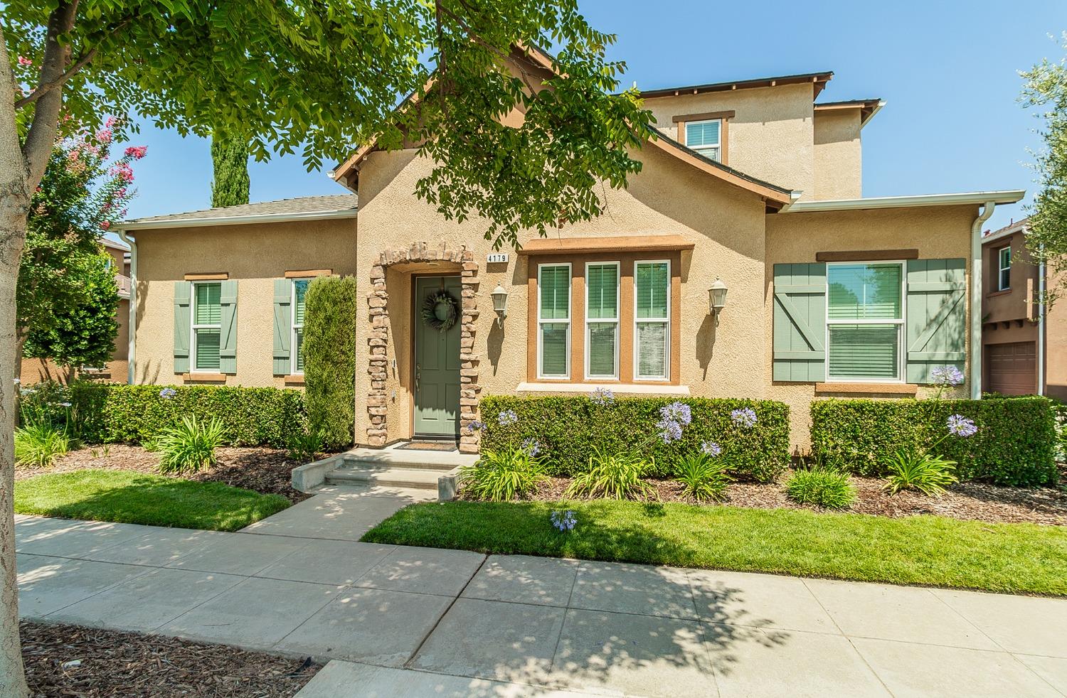 4179 Harlan Ranch Boulevard Clovis, CA 93619 - Photo 2 of 47 front view of a house with a yard