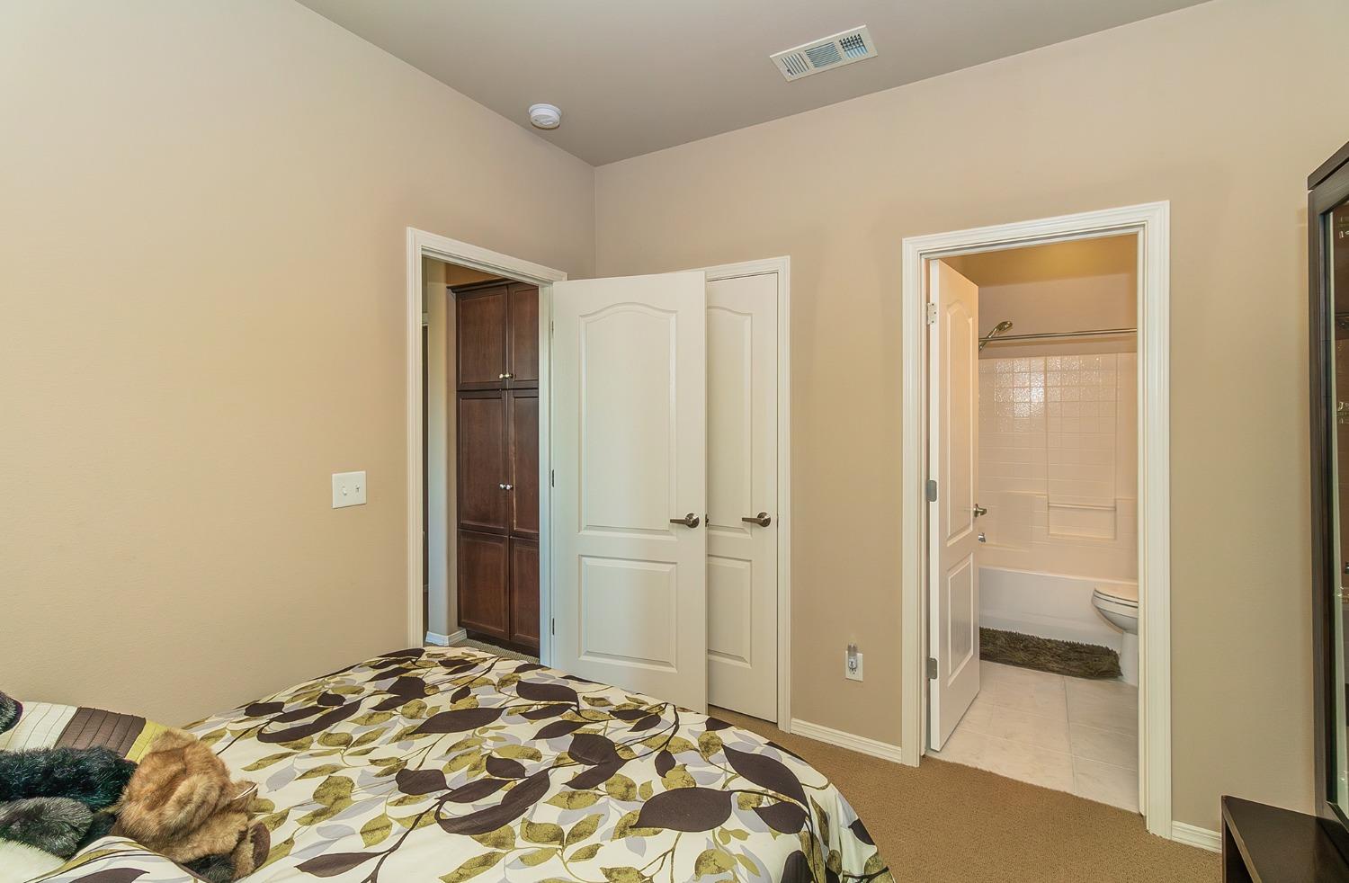4179 Harlan Ranch Boulevard Clovis, CA 93619 - Photo 23 of 47 a bedroom with a bed and a bathroom