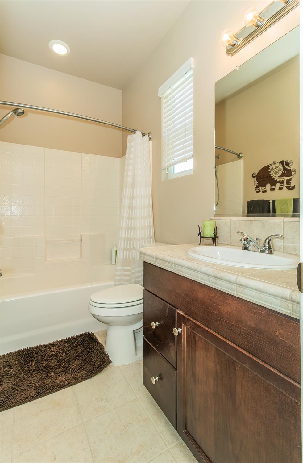 4179 Harlan Ranch Boulevard Clovis, CA 93619 - Photo 24 of 47 a bathroom with a double vanity sink a toilet and shower