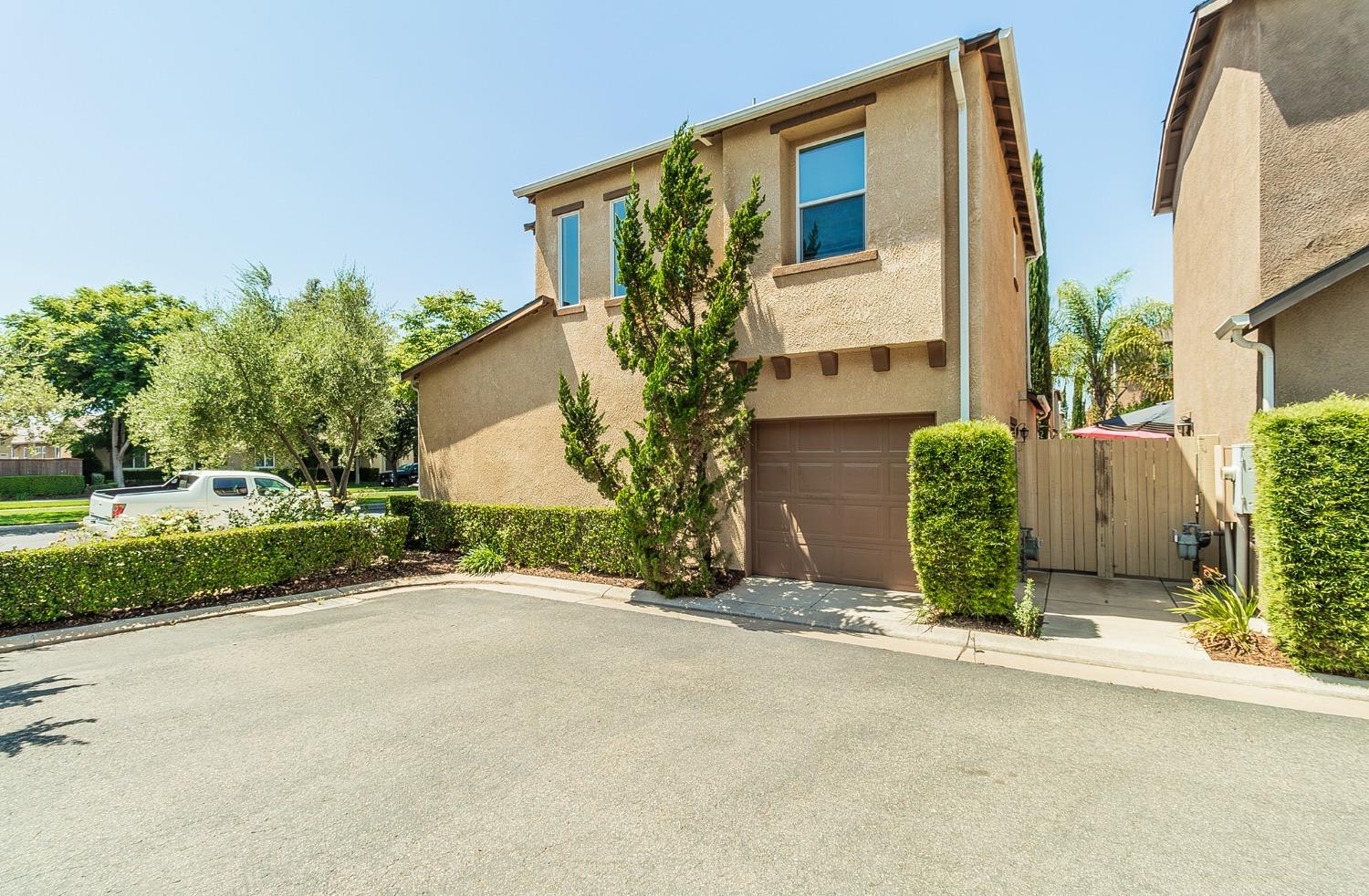 4179 Harlan Ranch Boulevard Clovis, CA 93619 - Photo 26 of 47 front view of a house with a garden