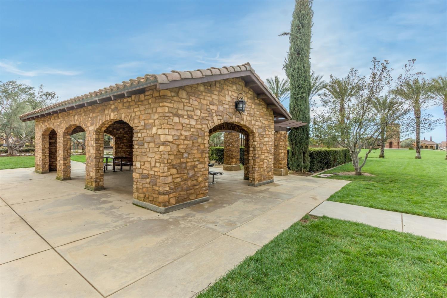 4179 Harlan Ranch Boulevard Clovis, CA 93619 - Photo 40 of 47 a front view of a house with garden